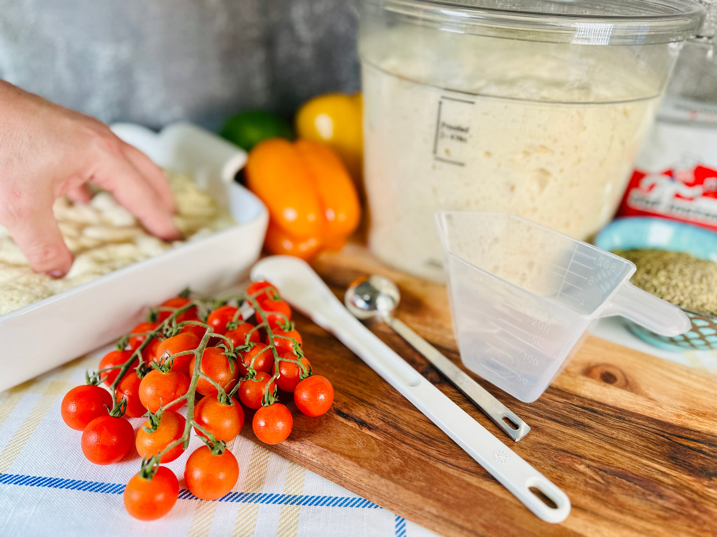 A kitchen scene featuring ingredients for making focaccia bread
